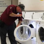 Batzner Pest Control's bed bug specialist inspecting a dryer in Wisconsin.