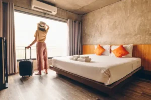 A guest looks out the window of her pest-free hotel room. Find out how to prevent pest entry in hotels with these tips.