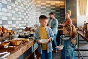 Happy family enjoying a hotel breakfast free from pests.