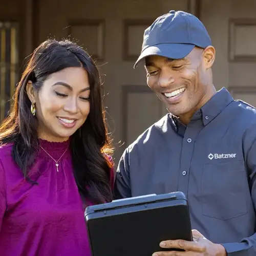 Batzner Pest Control technician shows a Wisconsin homeowner a quote for pest control service